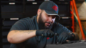 A WCP equipment tech doing maintenance on a piece of cleaning equipment.